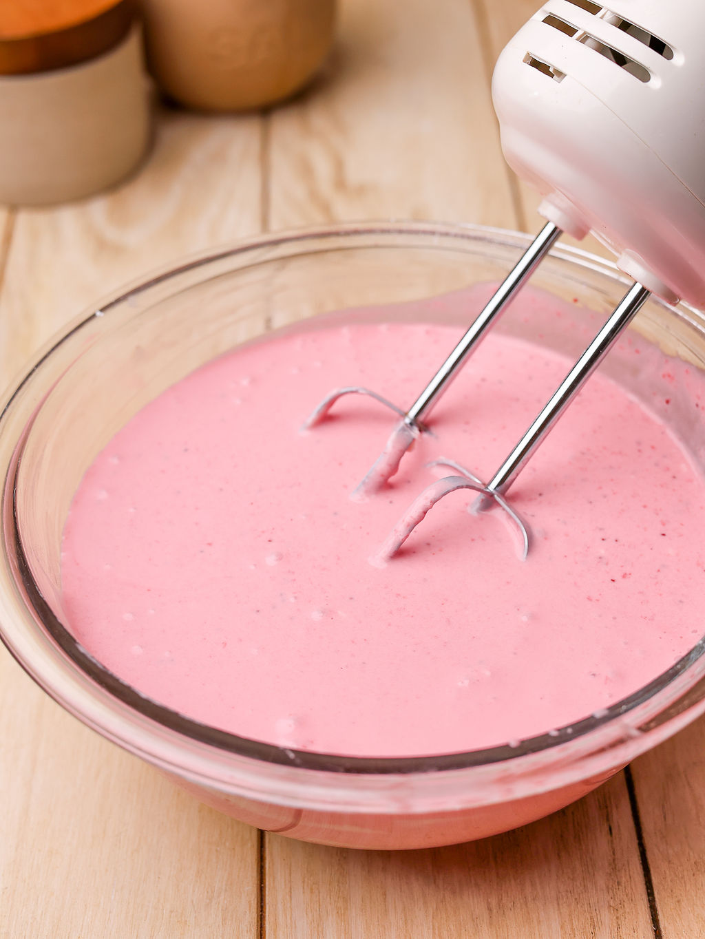 Mixing the strawberry icebox pie filling in a glass mixing bowl.