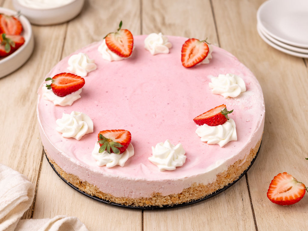 A delicious strawberry icebox pie topped with strawberries and whipped cream.