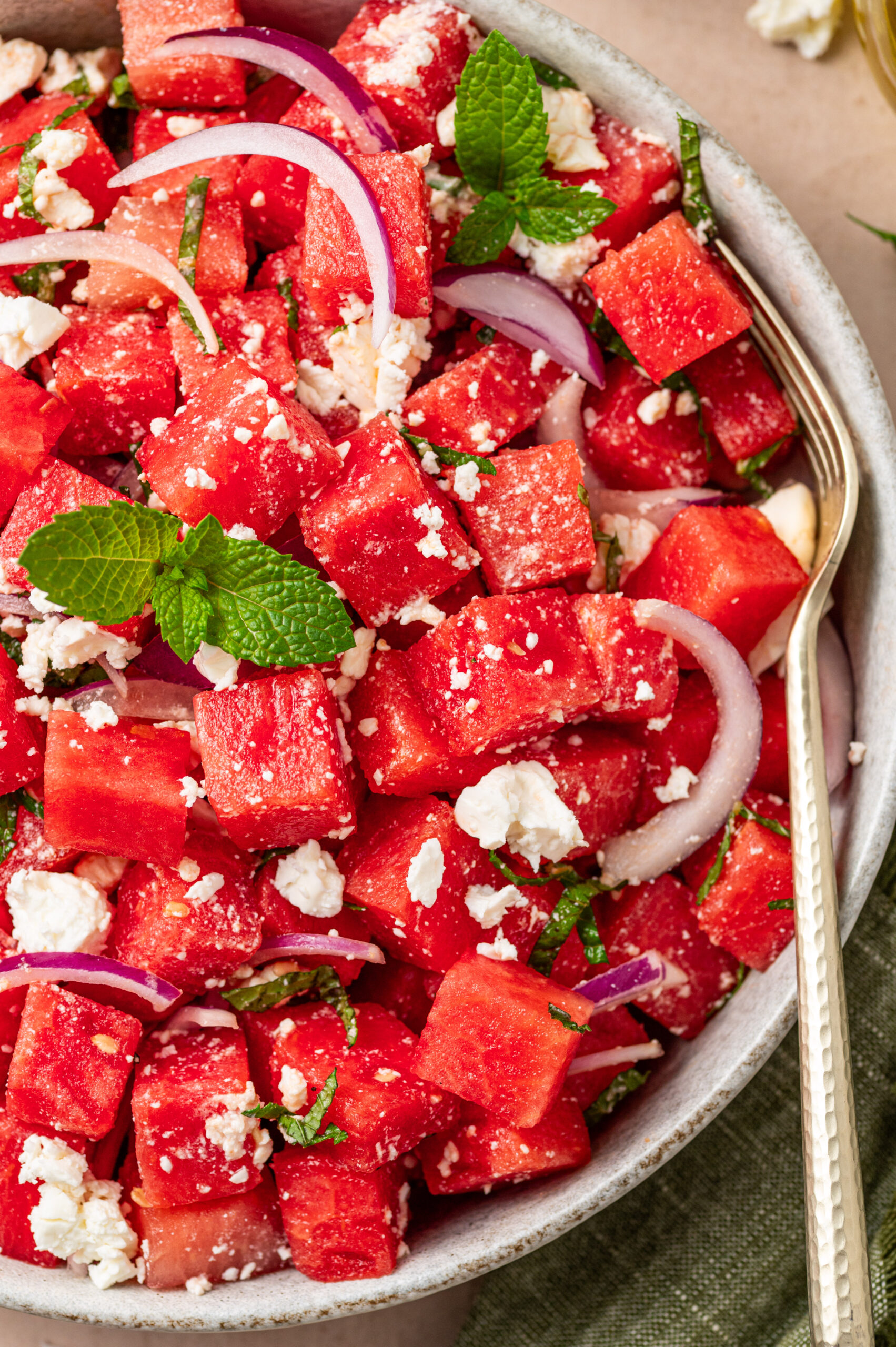 Close-up of watermelon feta and mint salad with a fork.