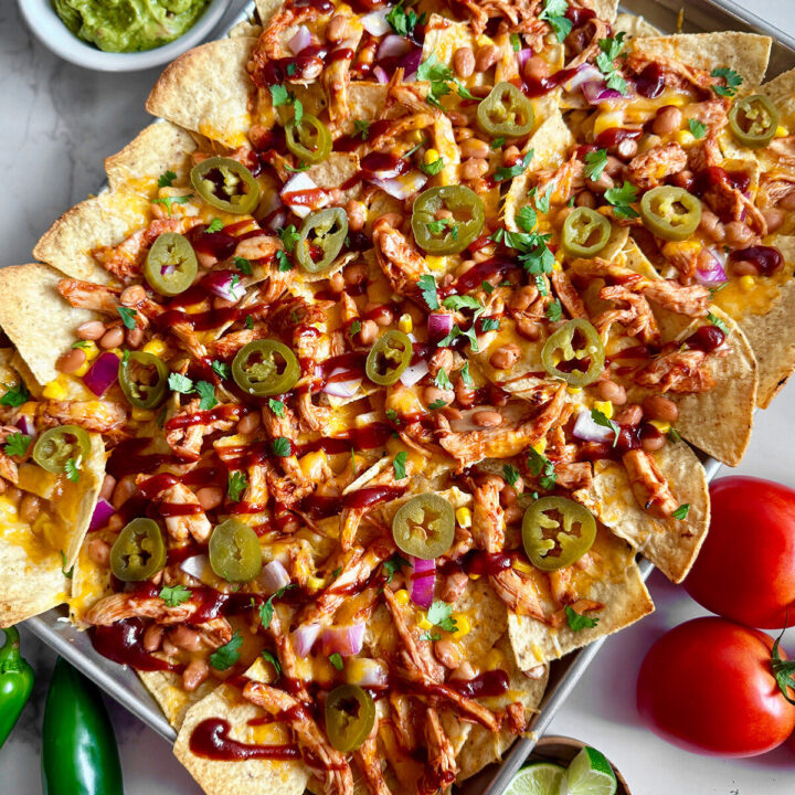 BBQ chicken nachos made on a sheet pan in the oven with this easy recipe.