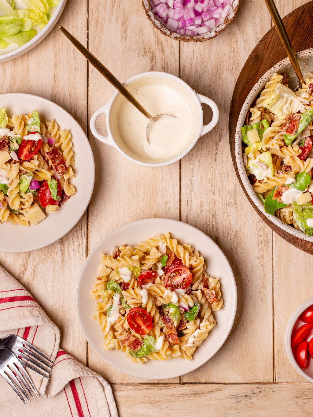 Servings of BLT pasta salad on white plates.