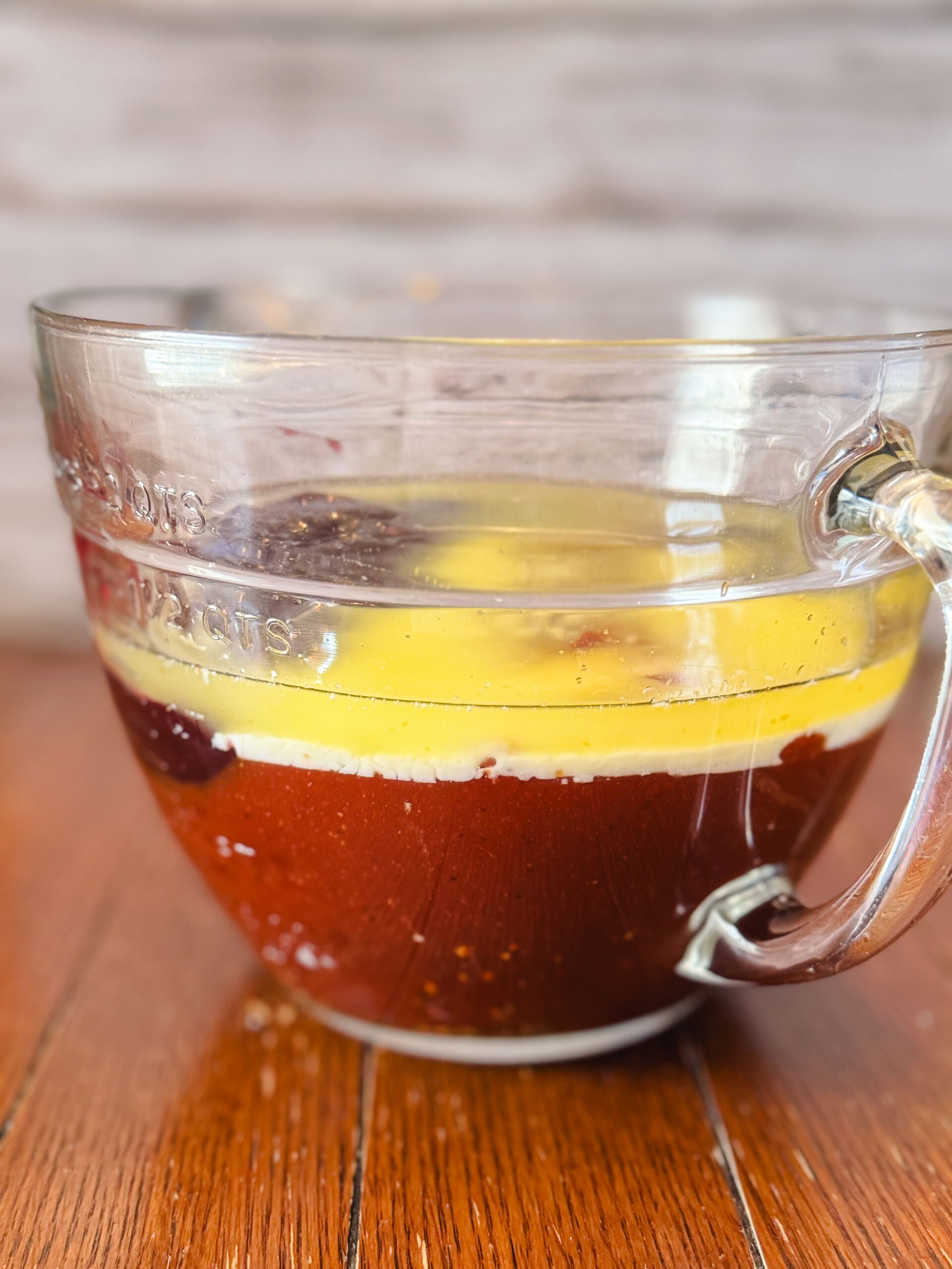 BBQ sauce, grape jelly, butter, and apple cider vinegar in a glass measuring cup.