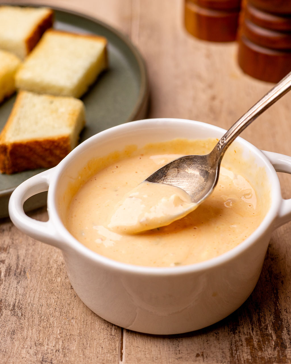 Homemade burger sauce in a white dish with a spoon.