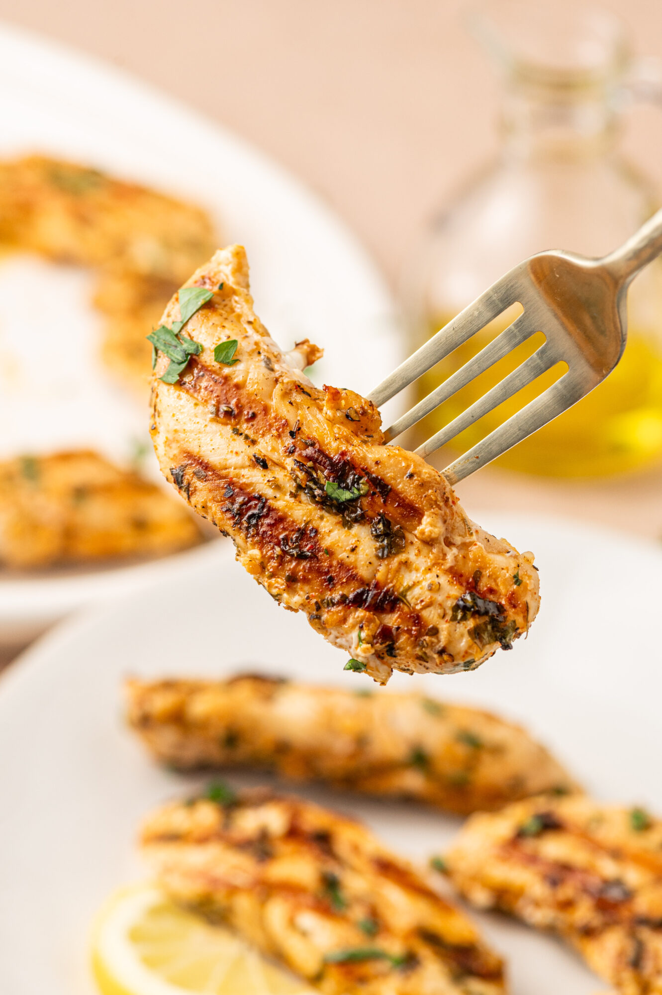 A forkful of grilled chicken tenders.