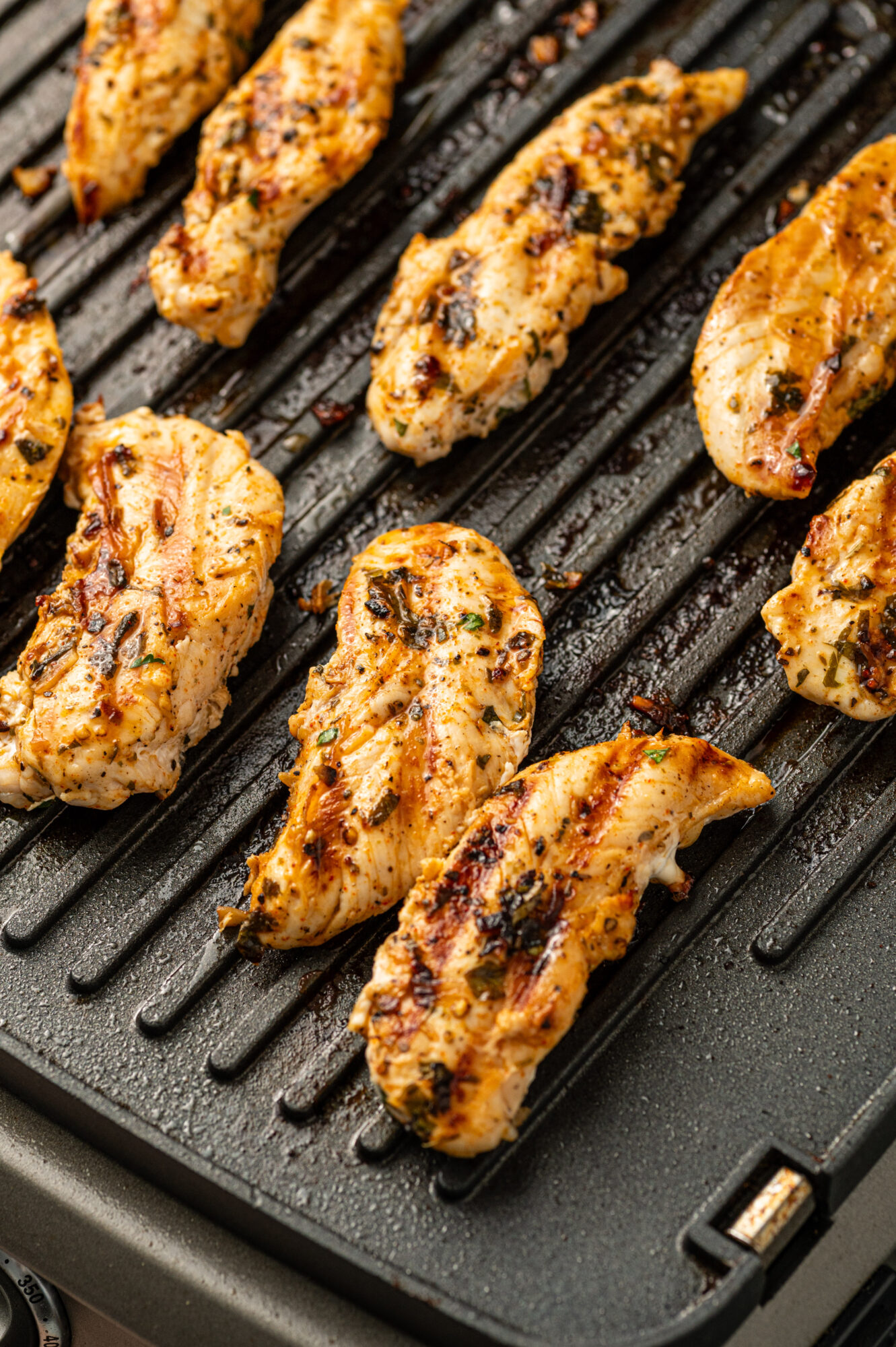 Chicken with grill marks on an indoor grill pan.