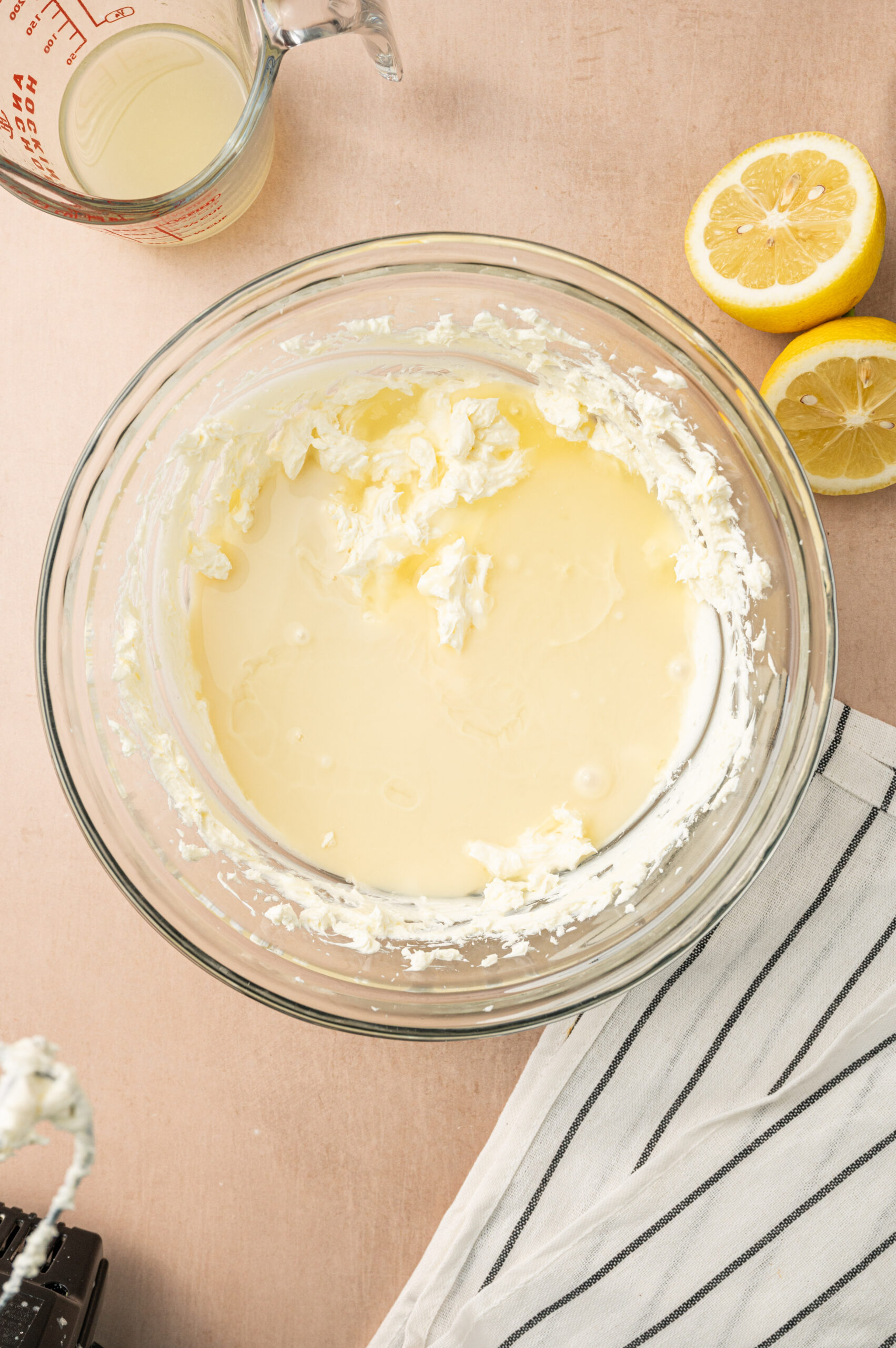 The lemon pie filling in a glass mixing bowl before getting mixed.