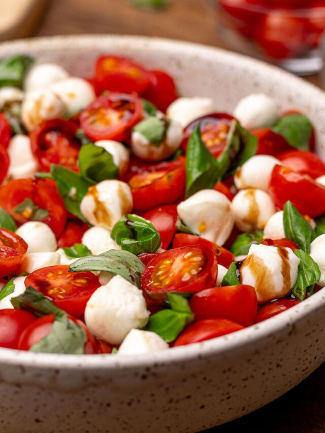 Caprese salad in a bowl with balsamic glaze.