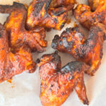 Close-up of air fryer BBQ chicken wings.
