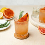 Charred grapefruit fizz with a grapefruit wedge and rosemary sprig.