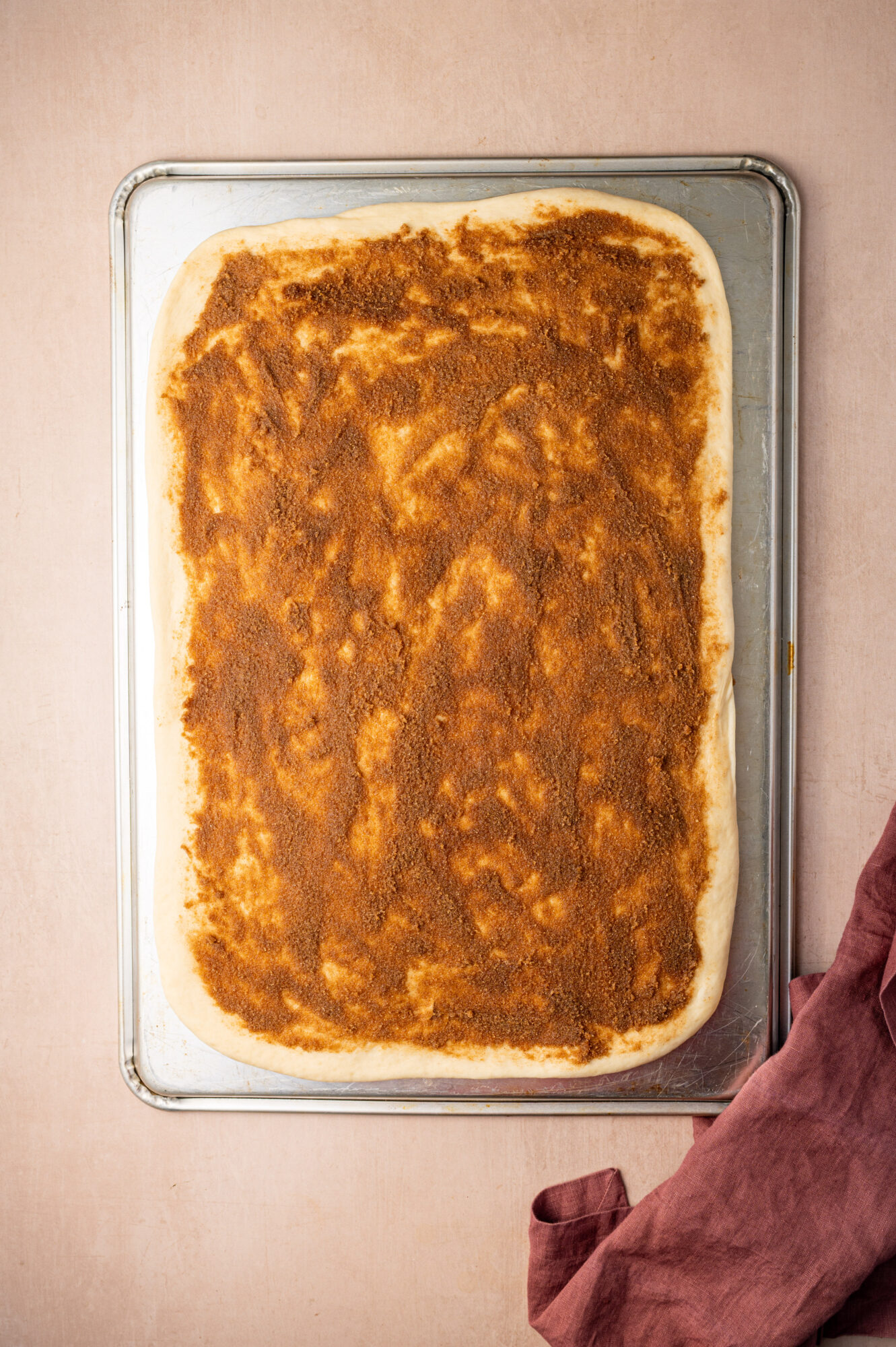 Cinnamon brown sugar spread on cinnamon roll dough.