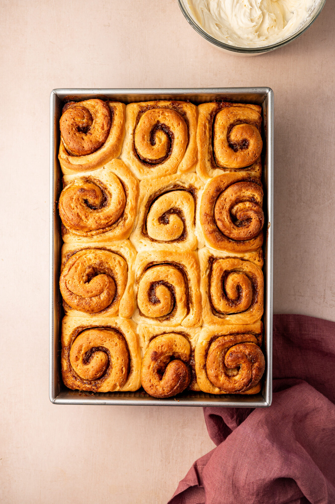 Cinnamon rolls in a baking dish straight out of the oven.