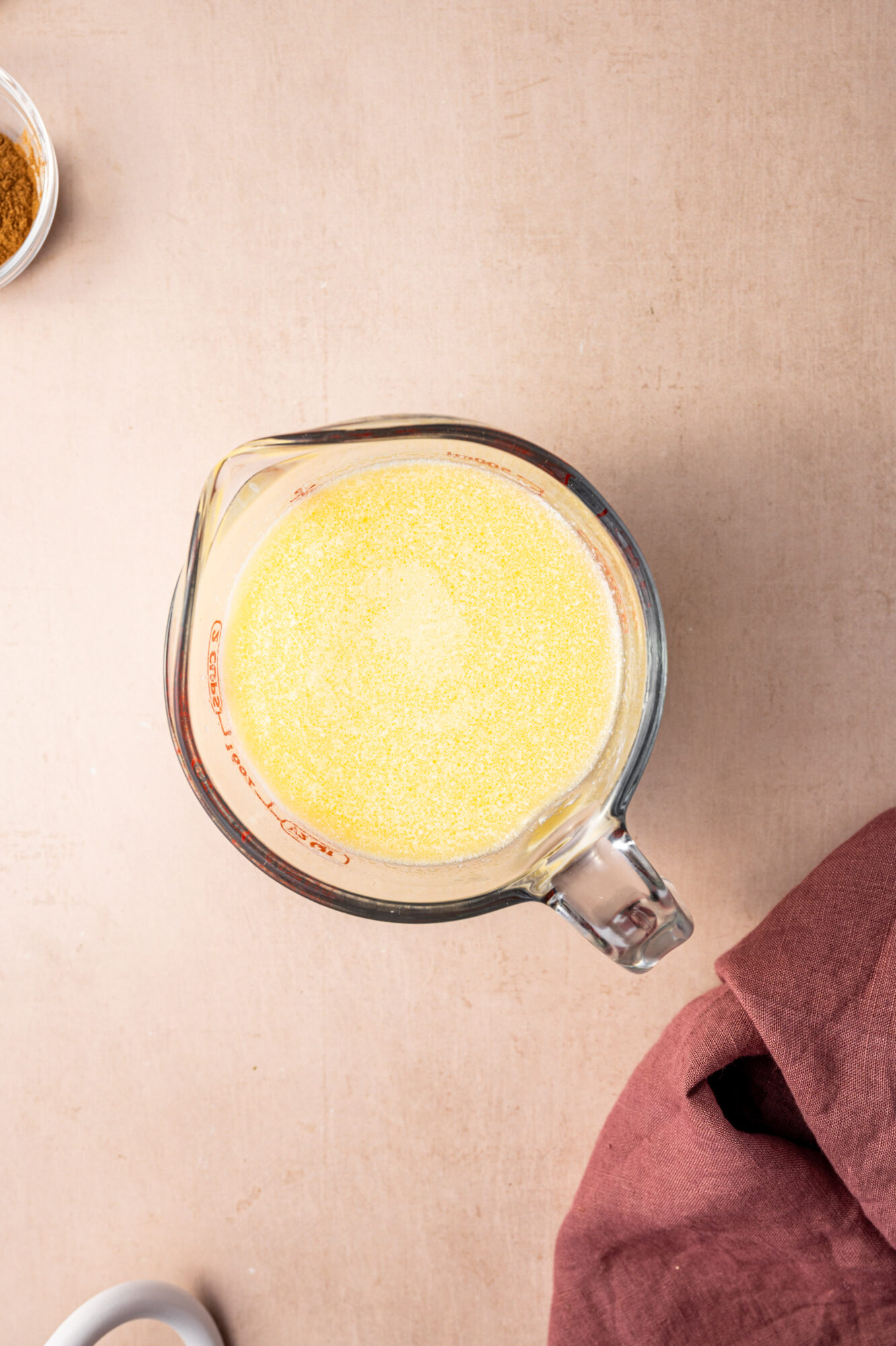 Melted butter in a glass measuring cup.