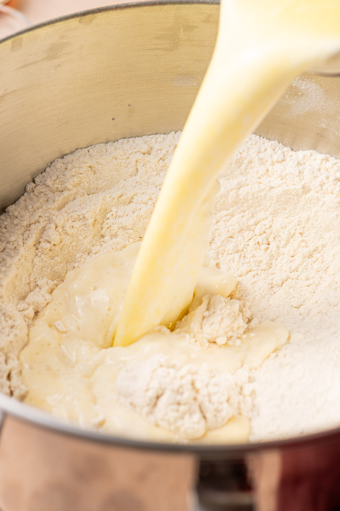 Pouring wet ingredients into dry ingredients.