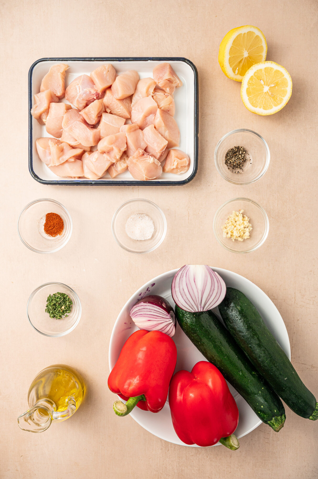 Ingredients for grilled chicken kabobs on a counter top.