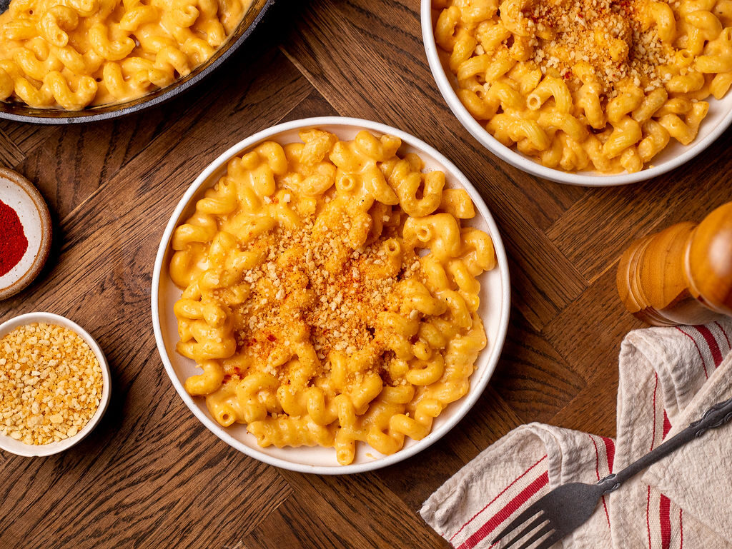 Mac and cheese in white bowls with breadcrumb topping.