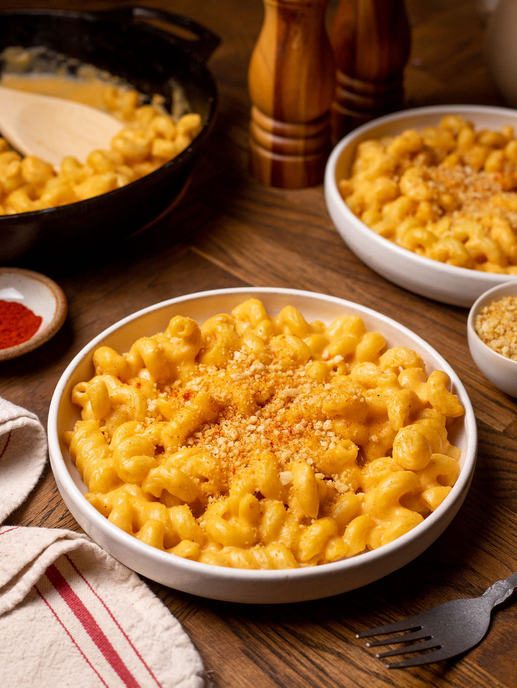 Mac and cheese in a white bowl with breadcrumb topping.