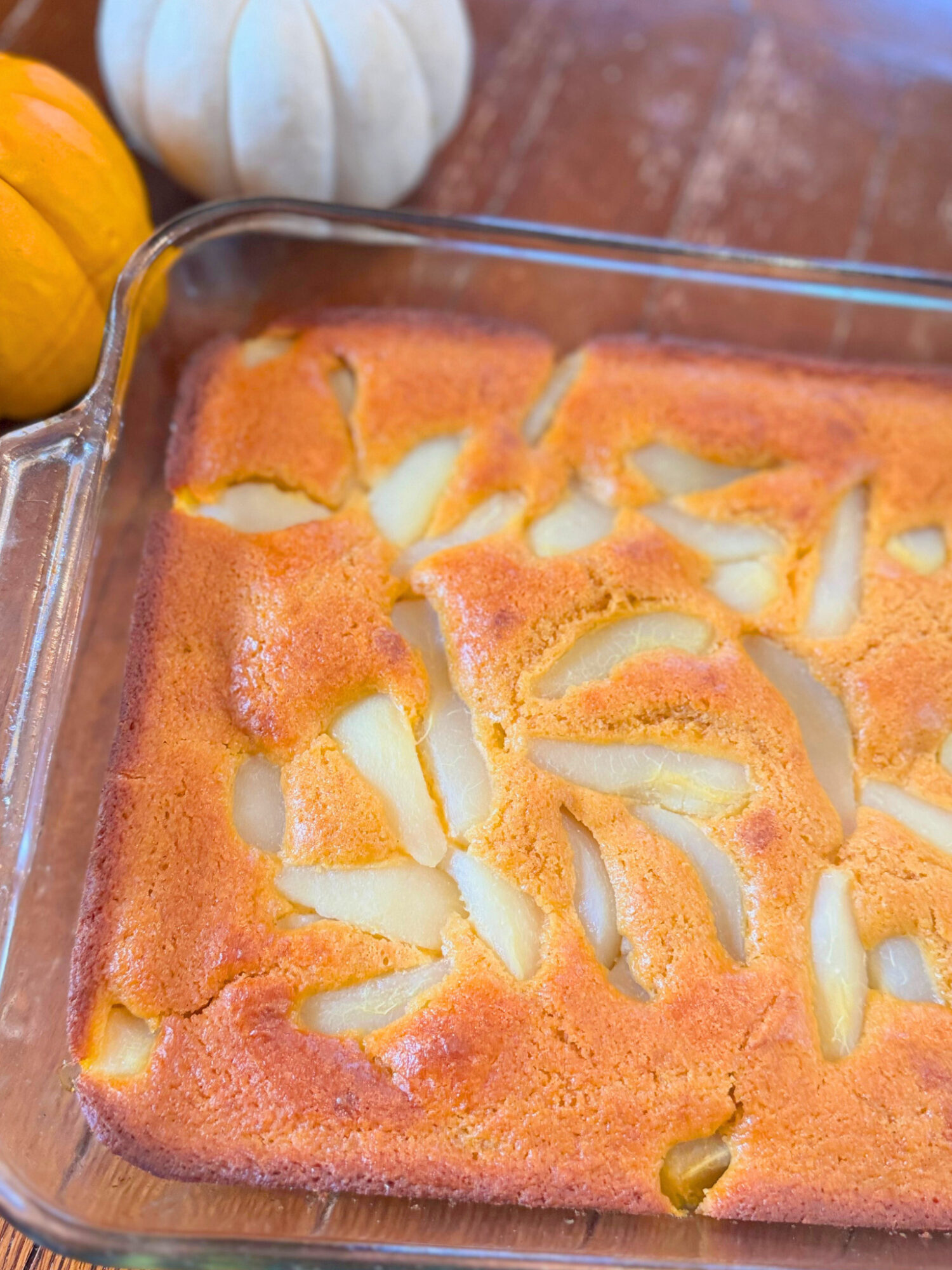 Close-up of pumpkin pear cobbler in a baking dish.