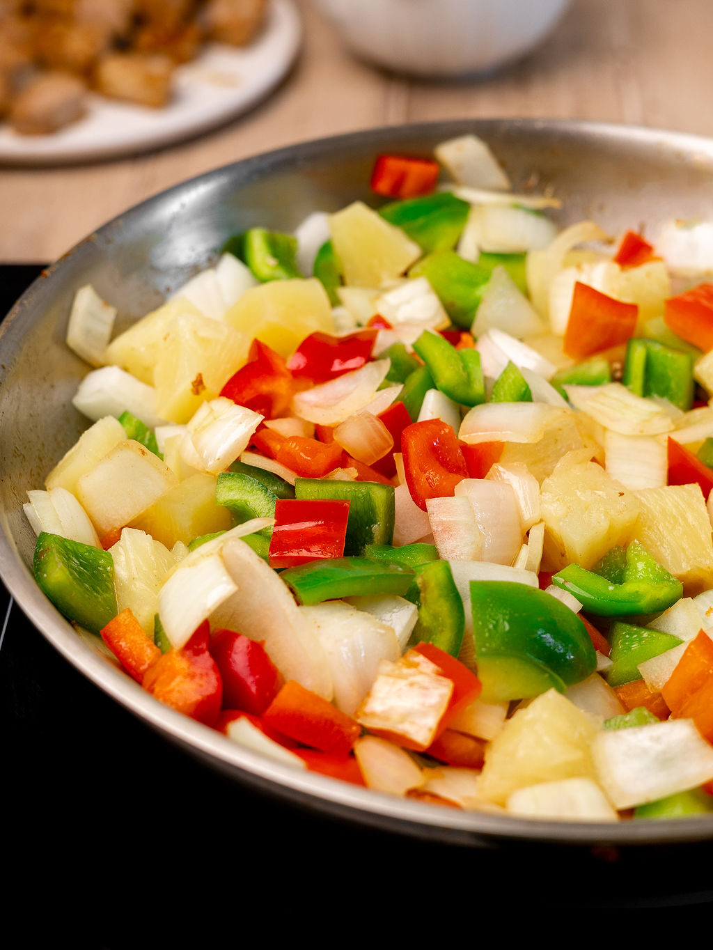 Diced onion and bell peppers in a mixing bowl.