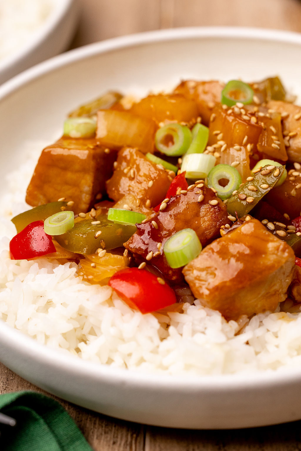 Close-up of sweet and sour pork on a bed of white rice.