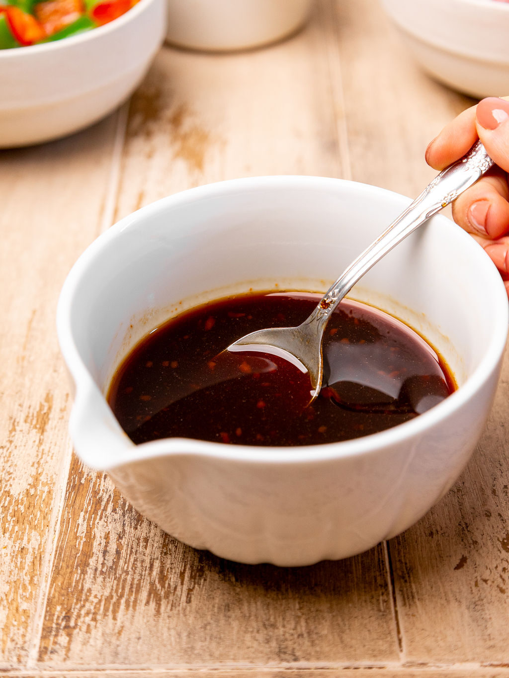Sweet and sour sauce in a small white bowl.