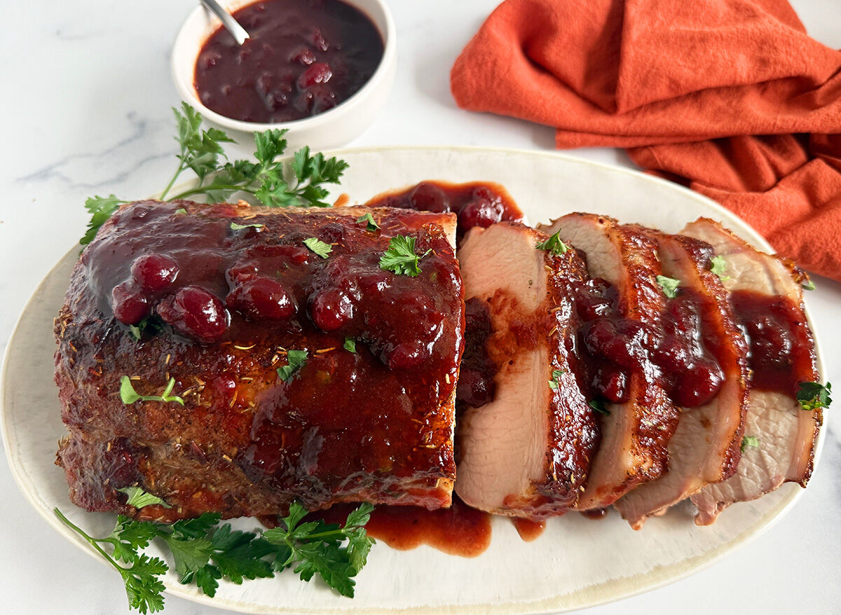 Cranberry balsamic pork loin roast served on a platter.