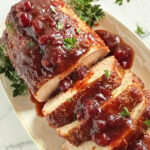 Balsamic cranberry pork loin roast served on a platter.