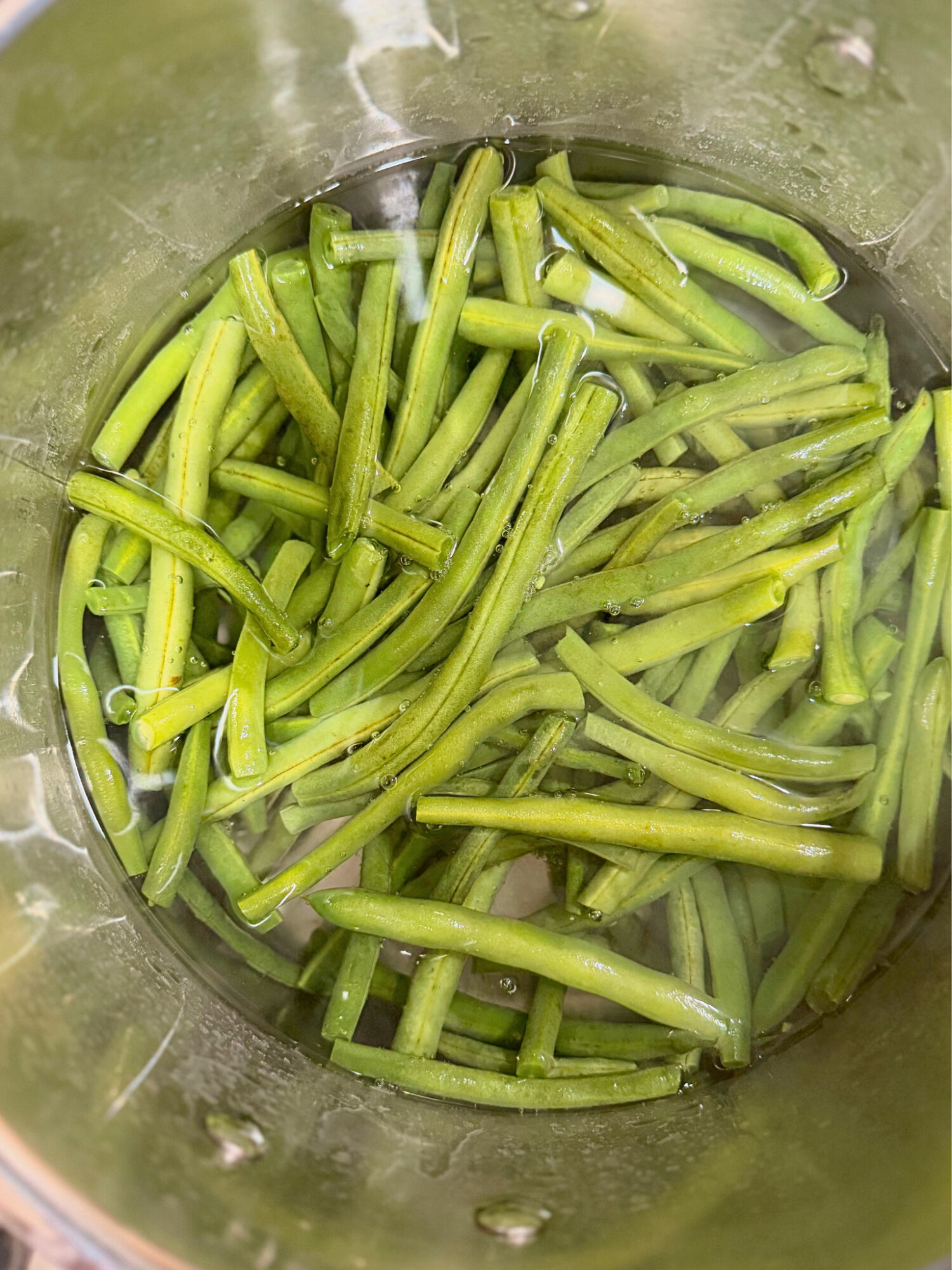 Cooked green beans in a pot.