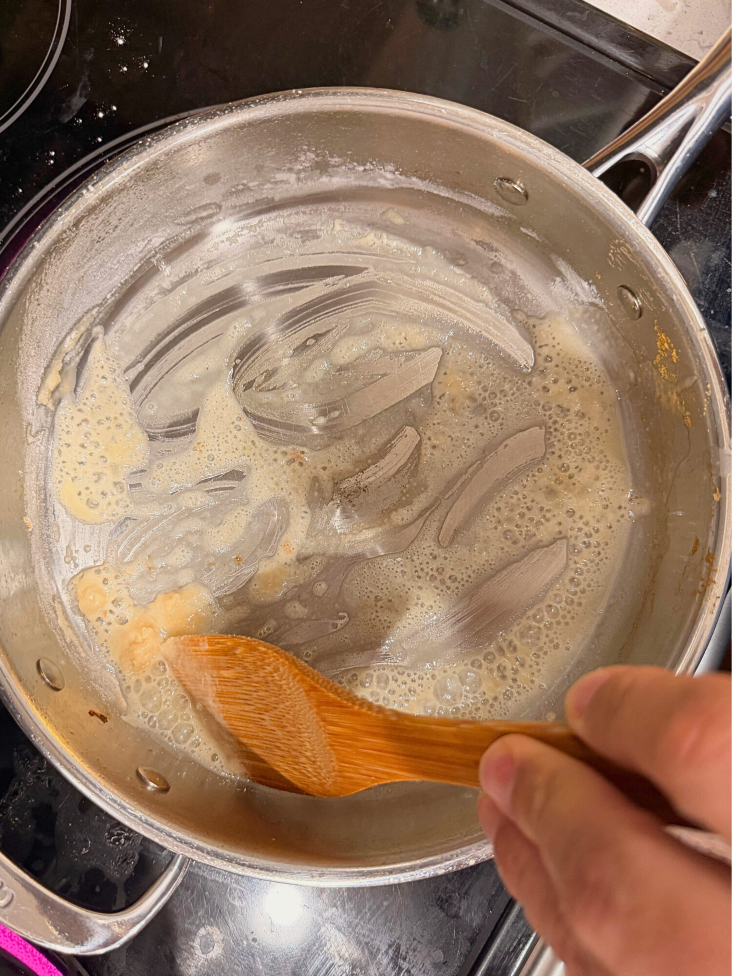 Making a roux in a pot over the stove.