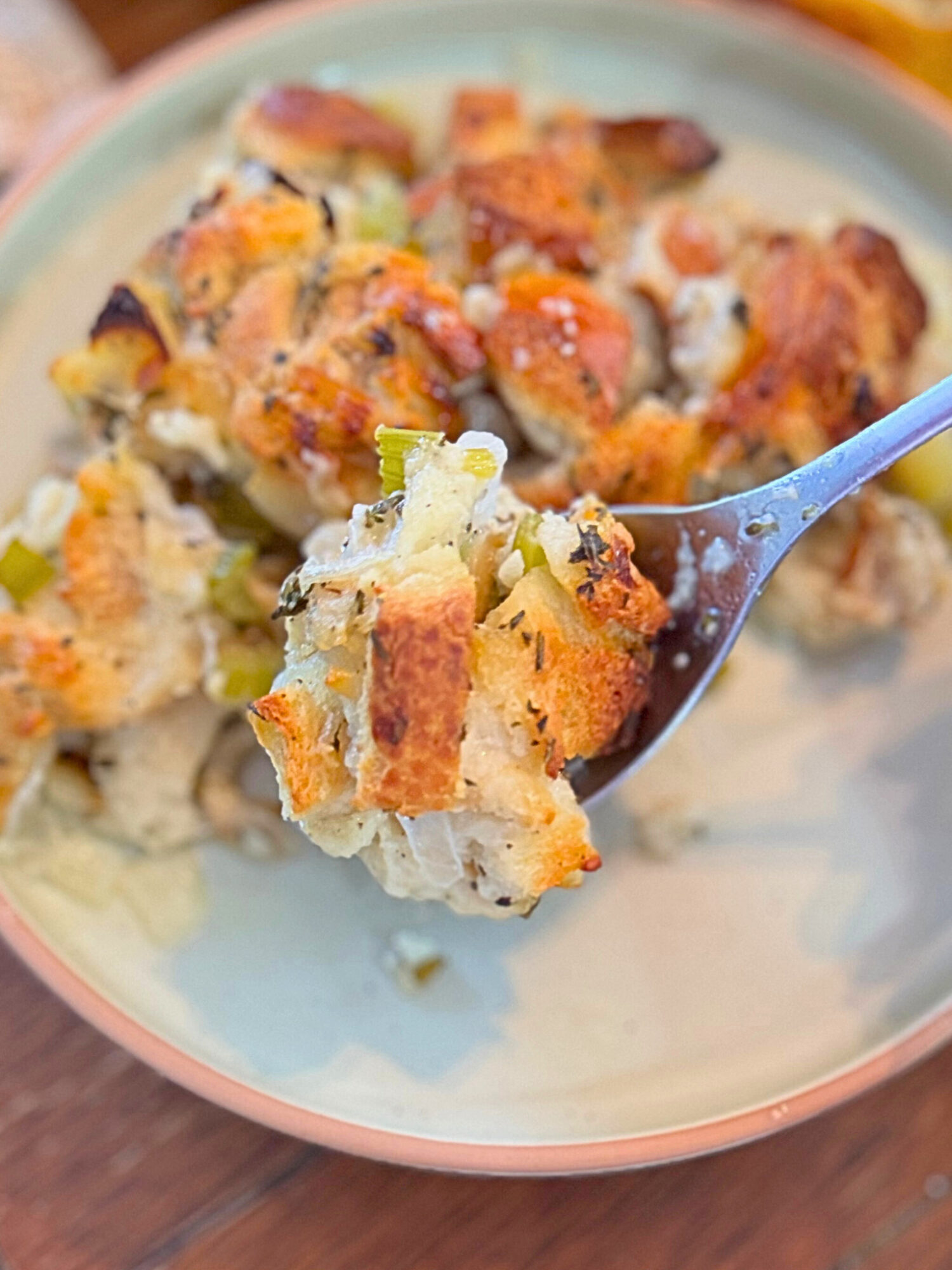A forkful of homemade stuffing on a plate.