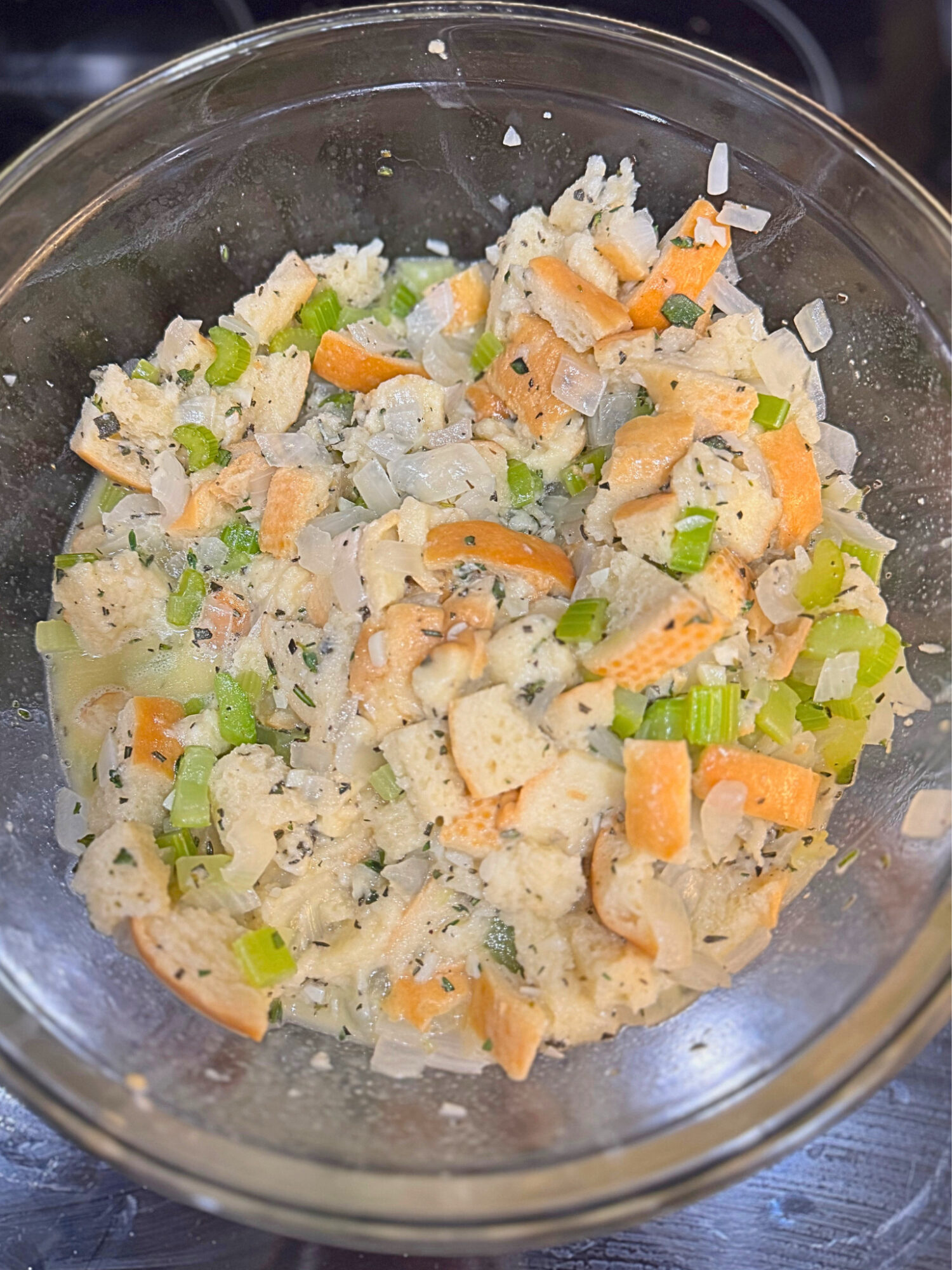 Stuffing mixture in a glass mixing bowl.