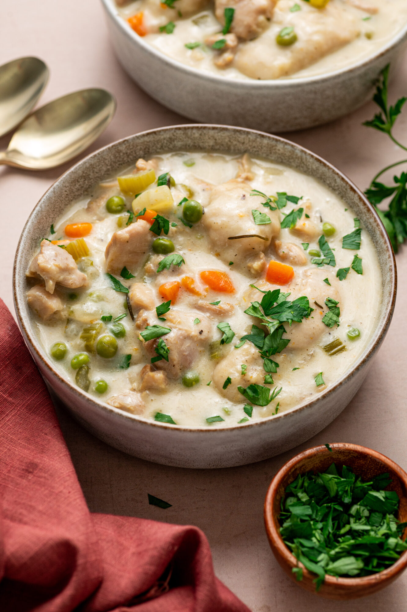 Instant Pot chicken and dumplings garnished with parsley.