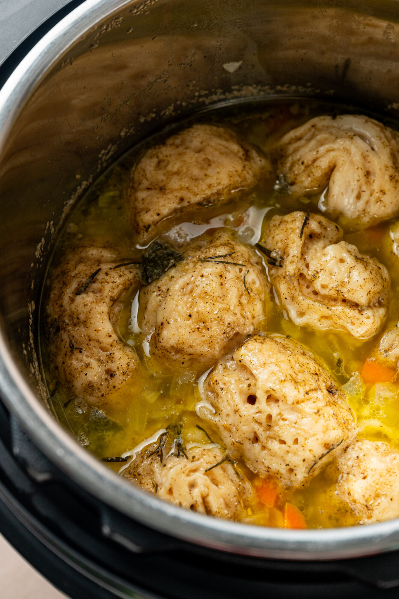 Cooked chicken and broth in an Instant Pot.