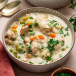 Instant Pot chicken and dumplings garnished with parsley.