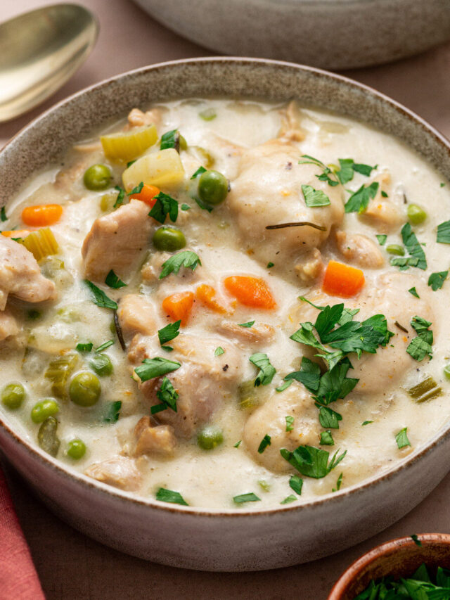 Instant Pot chicken and dumplings garnished with parsley.