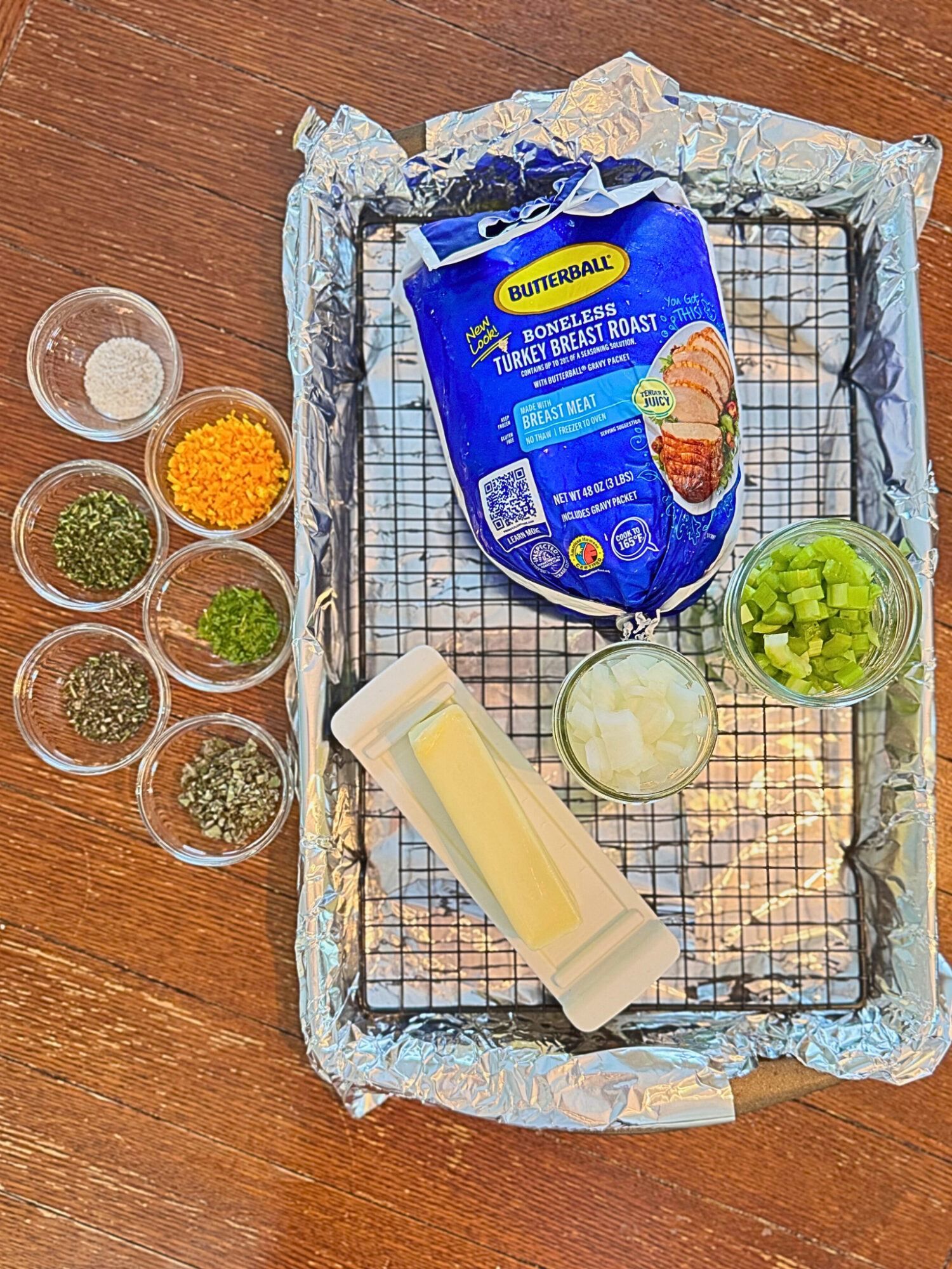 Ingredients for oven-roasted turkey breast on a wooden table.