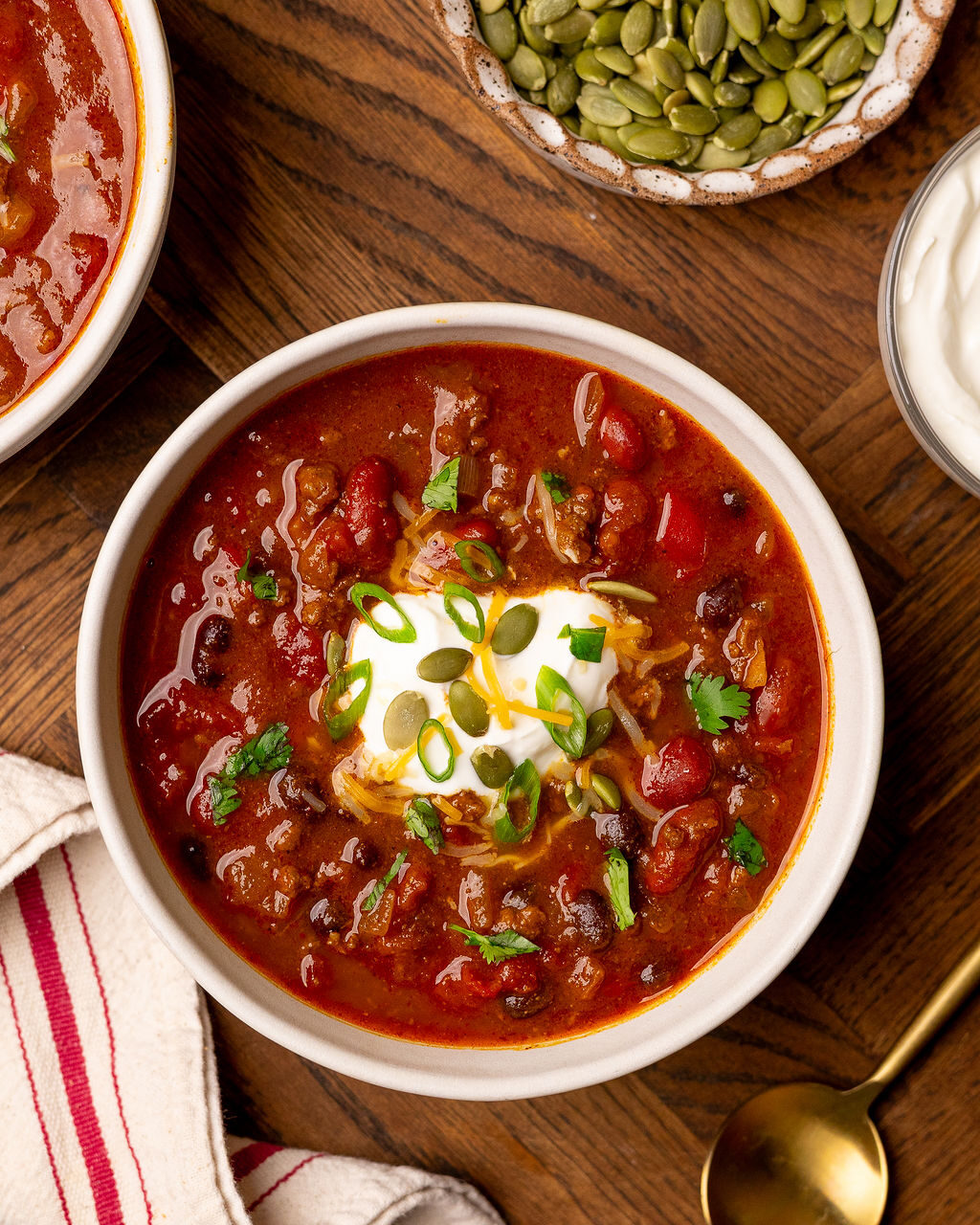 Aerial view of pumpkin chili on a wooden surface,