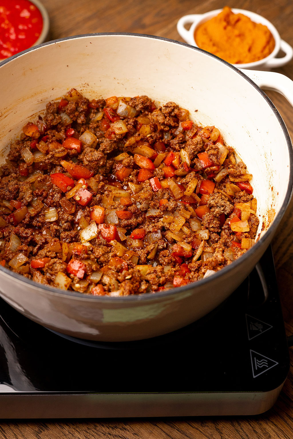 Spiced, browned beef and vegetables in a Dutch oven.