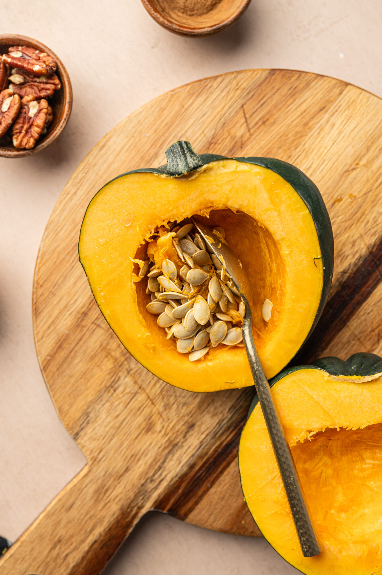 Scooping the seeds out of an acorn squash.