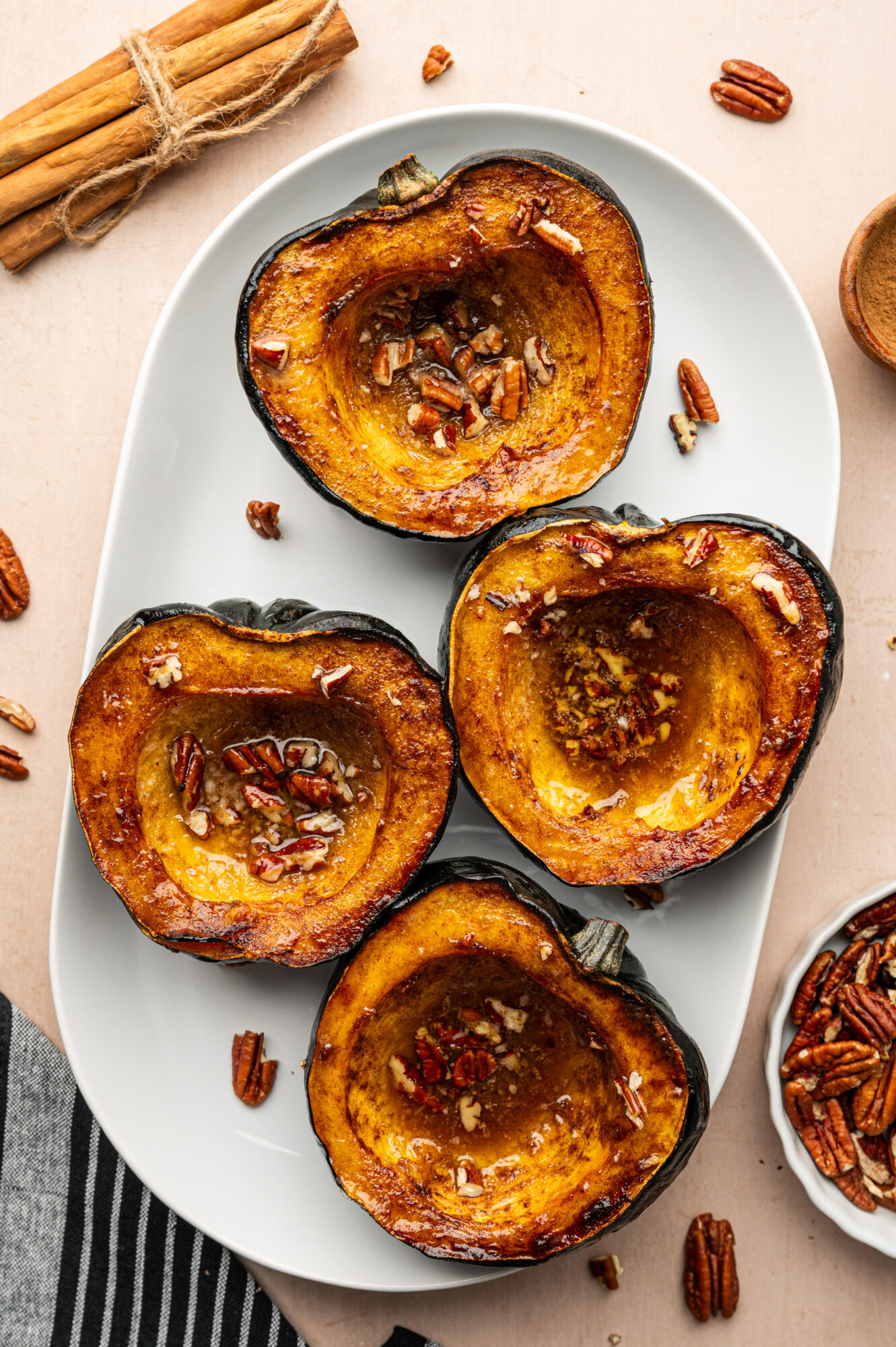 A serving of roasted acorn squash topped with pecans.