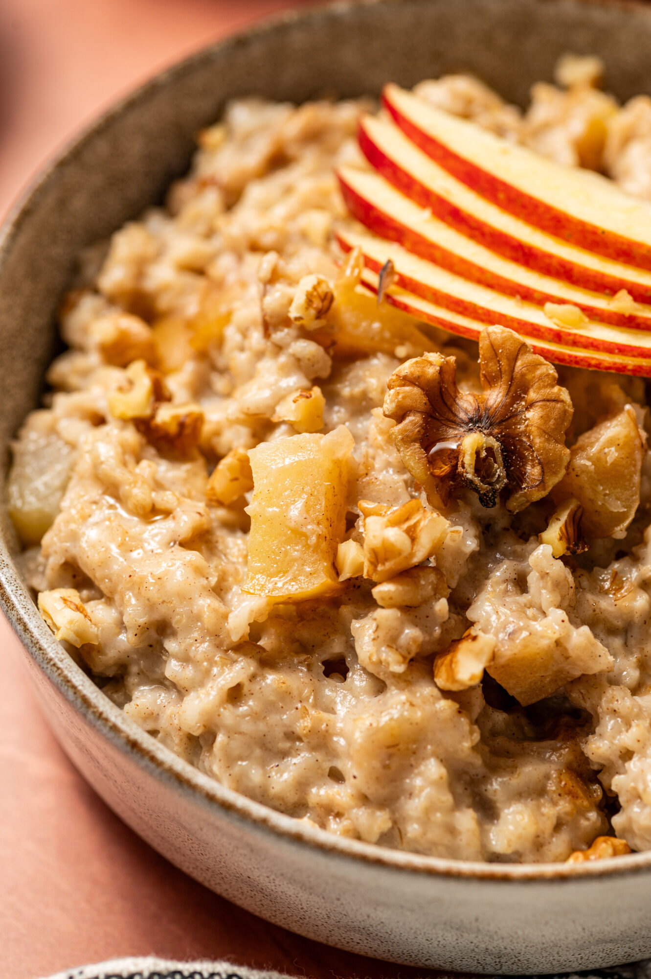 Close-up of apple cinnamon oatmeal topped with apple slices.