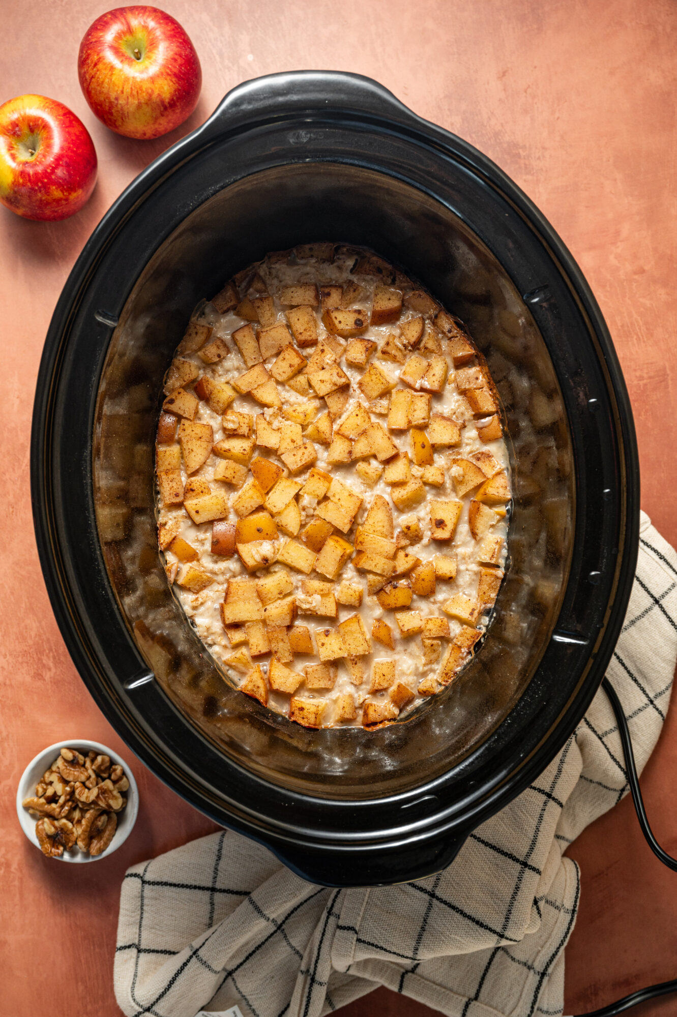 Cooked apple pieces in a slow cooker.