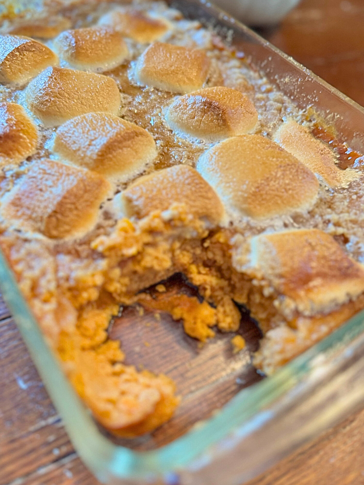Sweet potato casserole with a slice taken out of it.