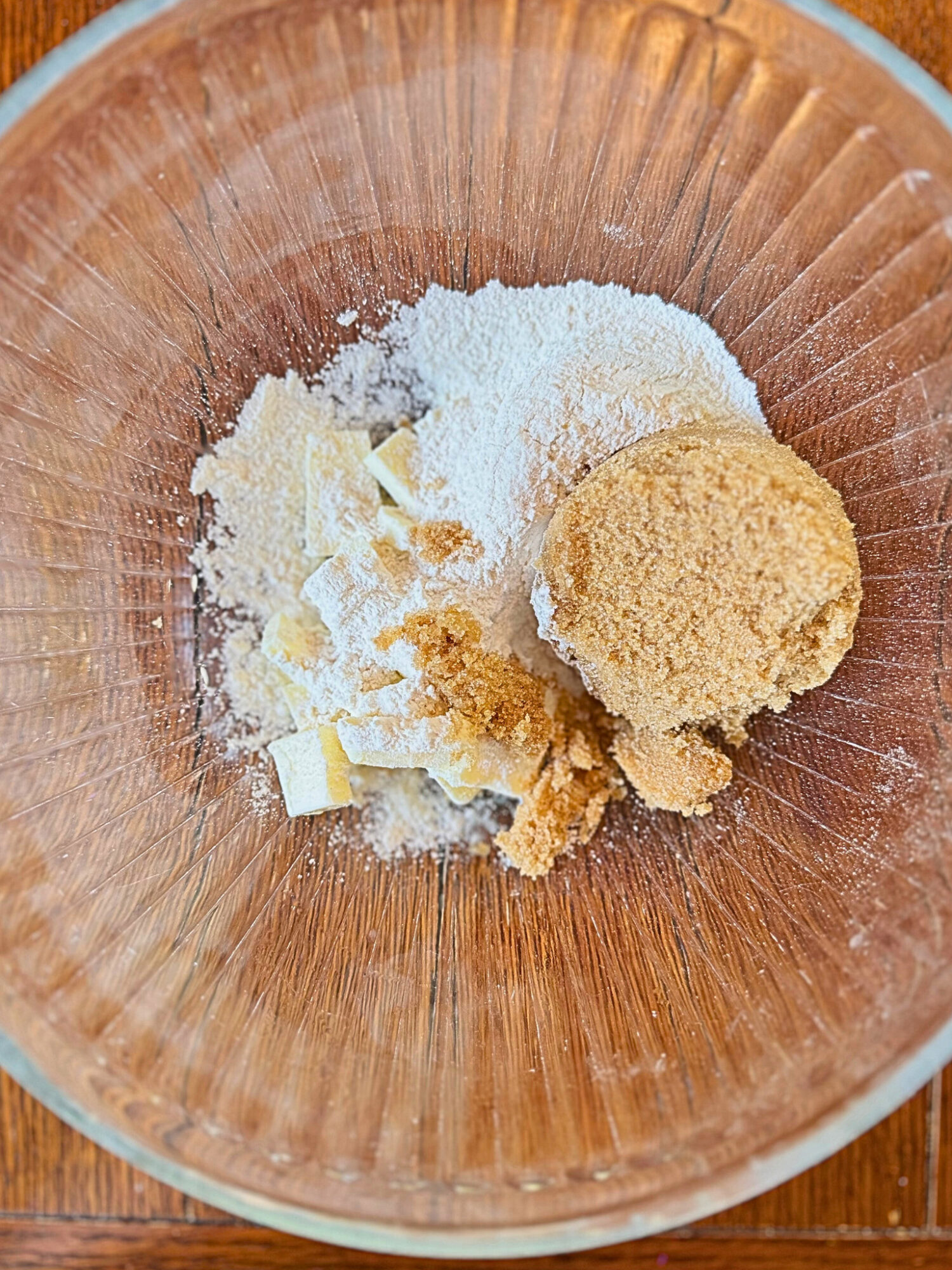 Ingredients for streusel topping in a glass mixing bowl.