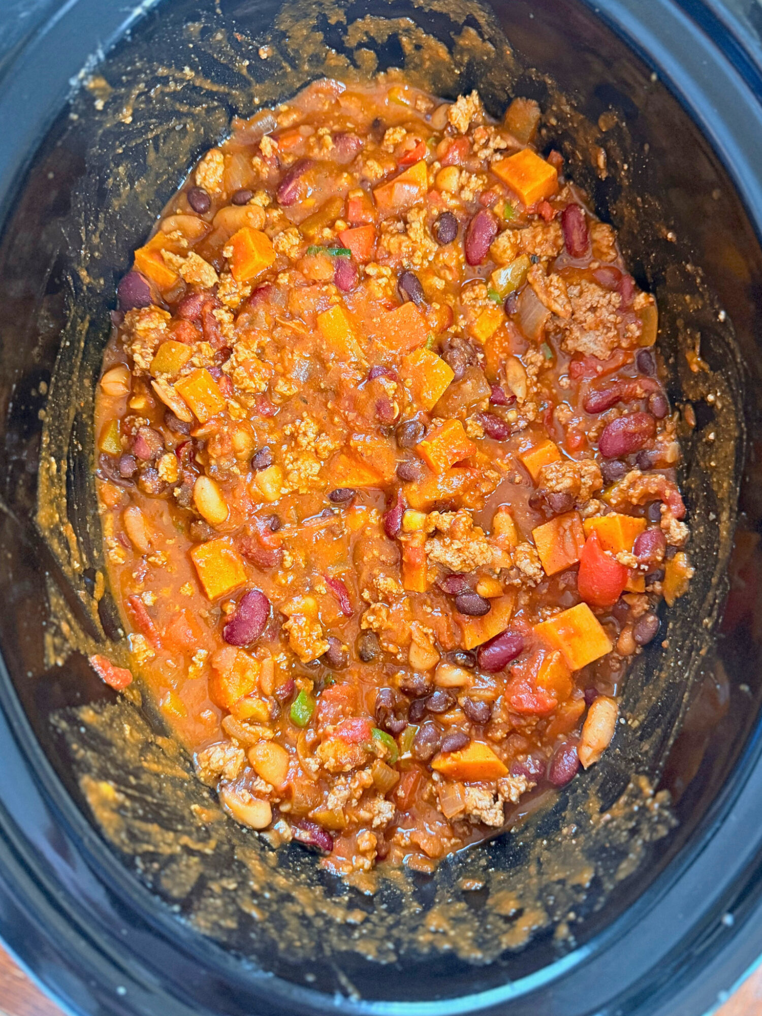 Turkey and sweet potato chili in a slow cooker ready to eat.