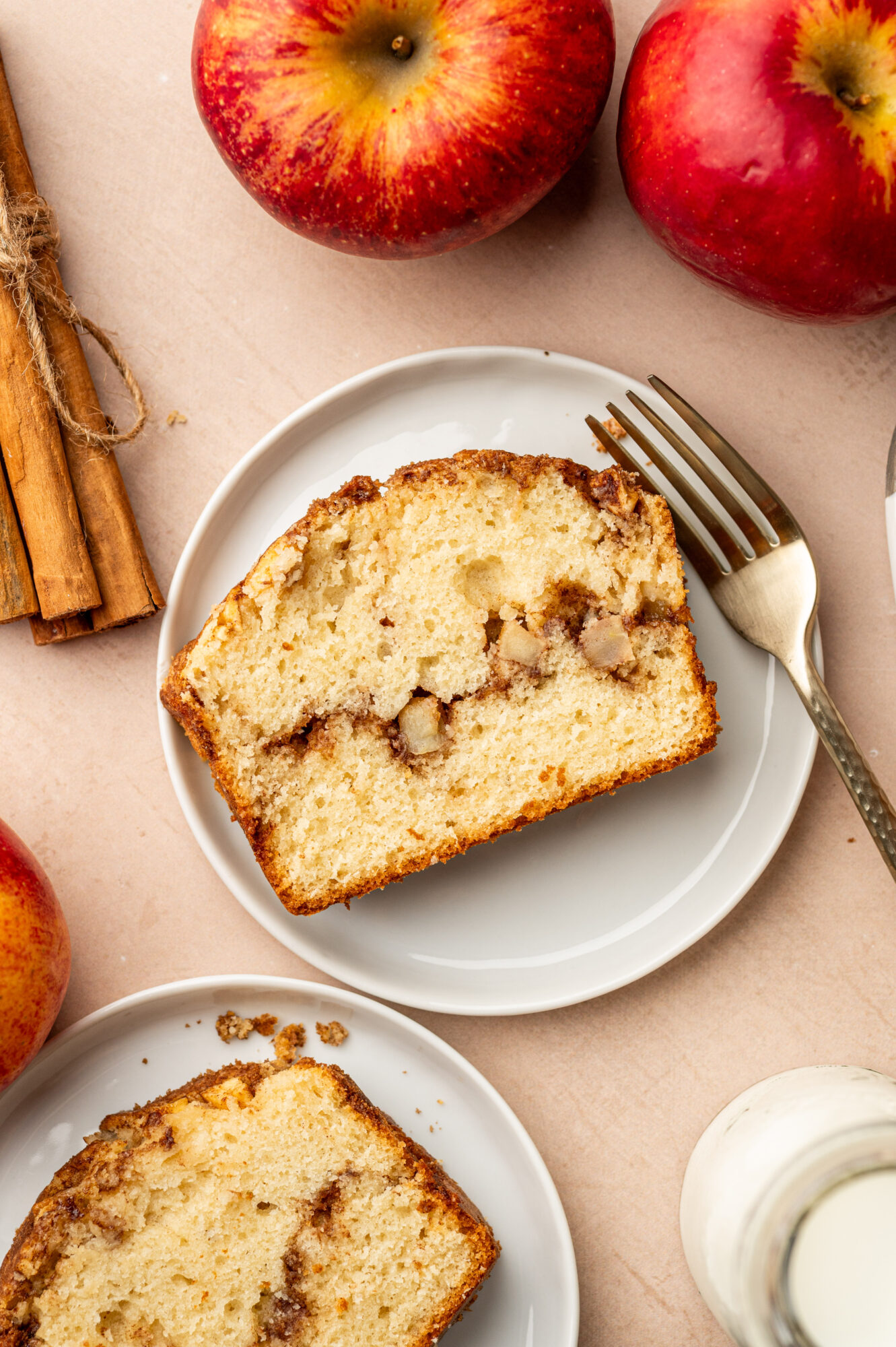 A slice of apple cinnamon bread surrounded by ingredients.