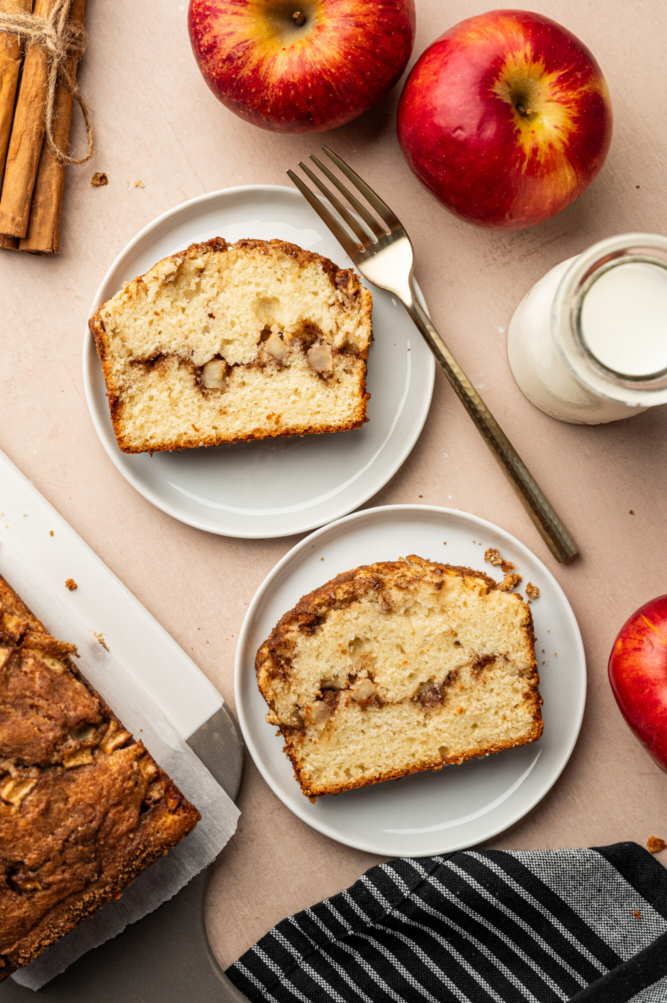 Two servings of apple cinnamon bread surrounded by ingredients.