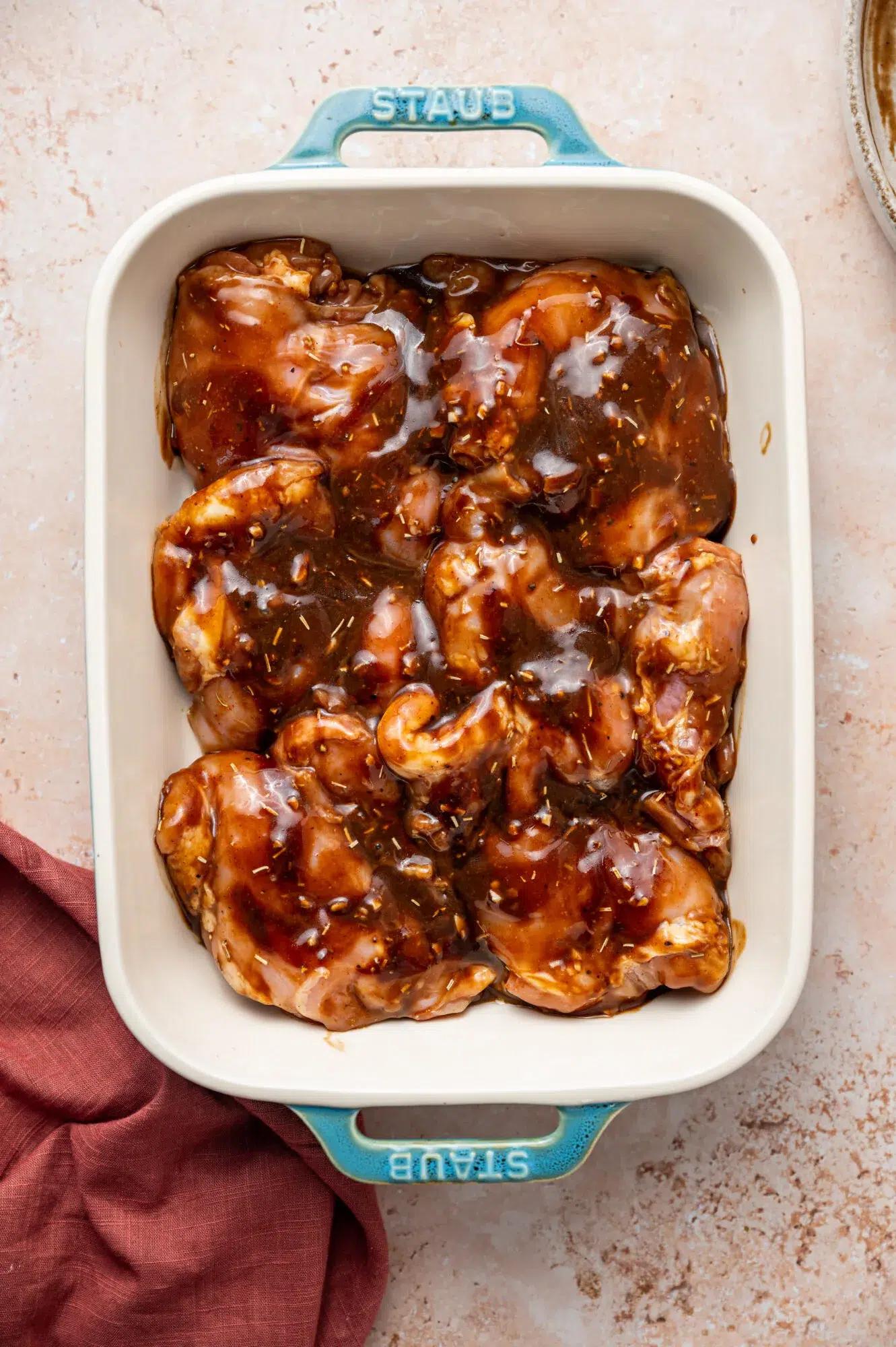 Chicken thighs glazes with balsamic and Dijon mustard ready to bake.