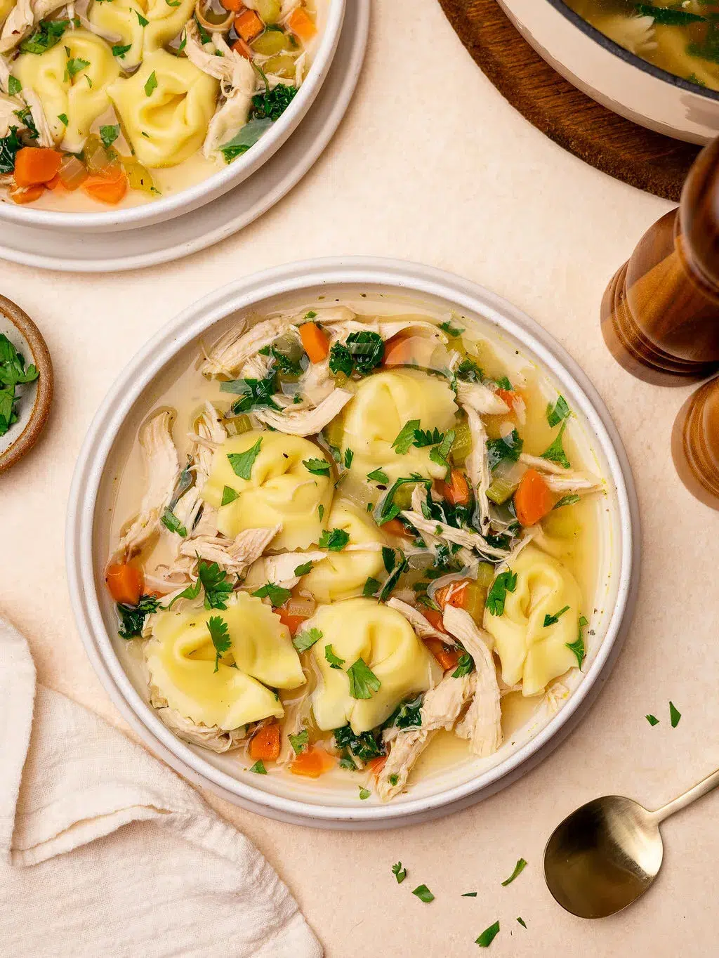 Two bowls of chicken tortellini soup.