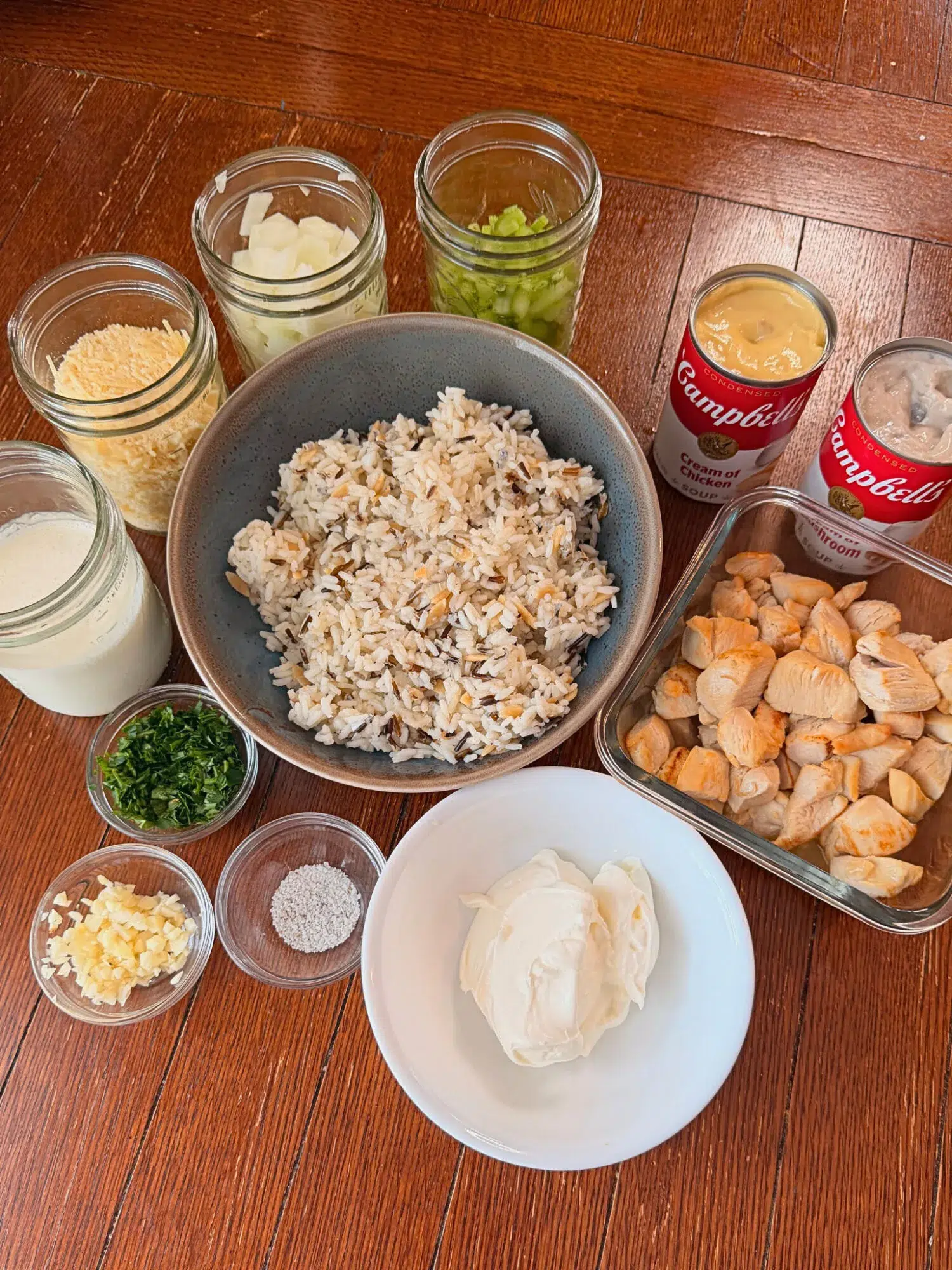 Ingredients for chicken wild rice bake on a wooden table.
