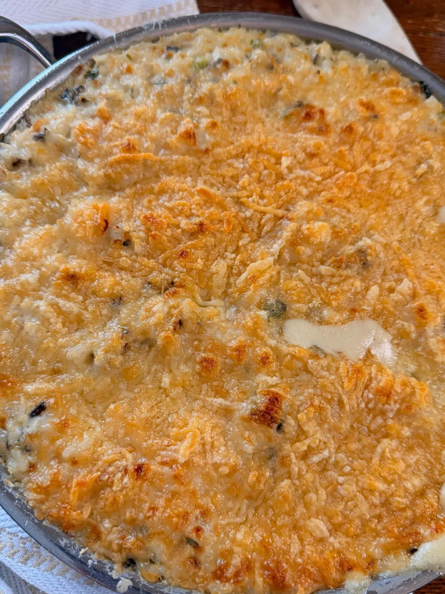 Close-up of golden parmesan crust for chicken wild rice bake.
